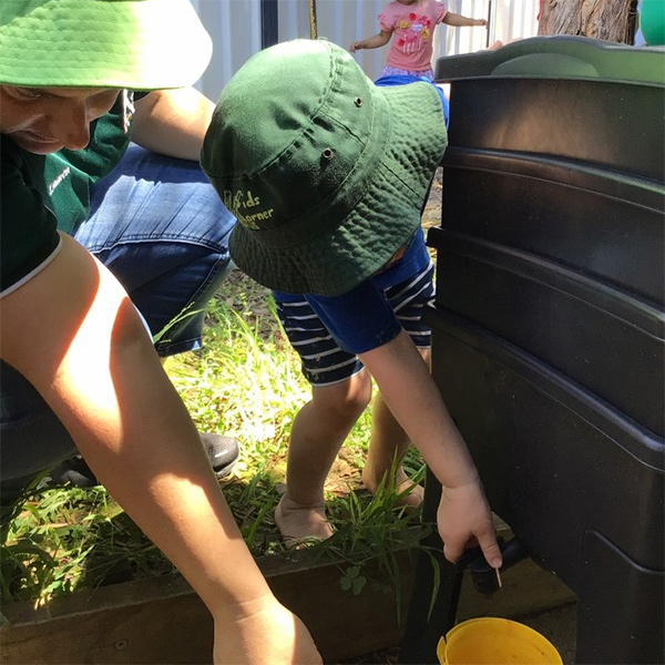 young boy interested in worm compost at kids korner nowra